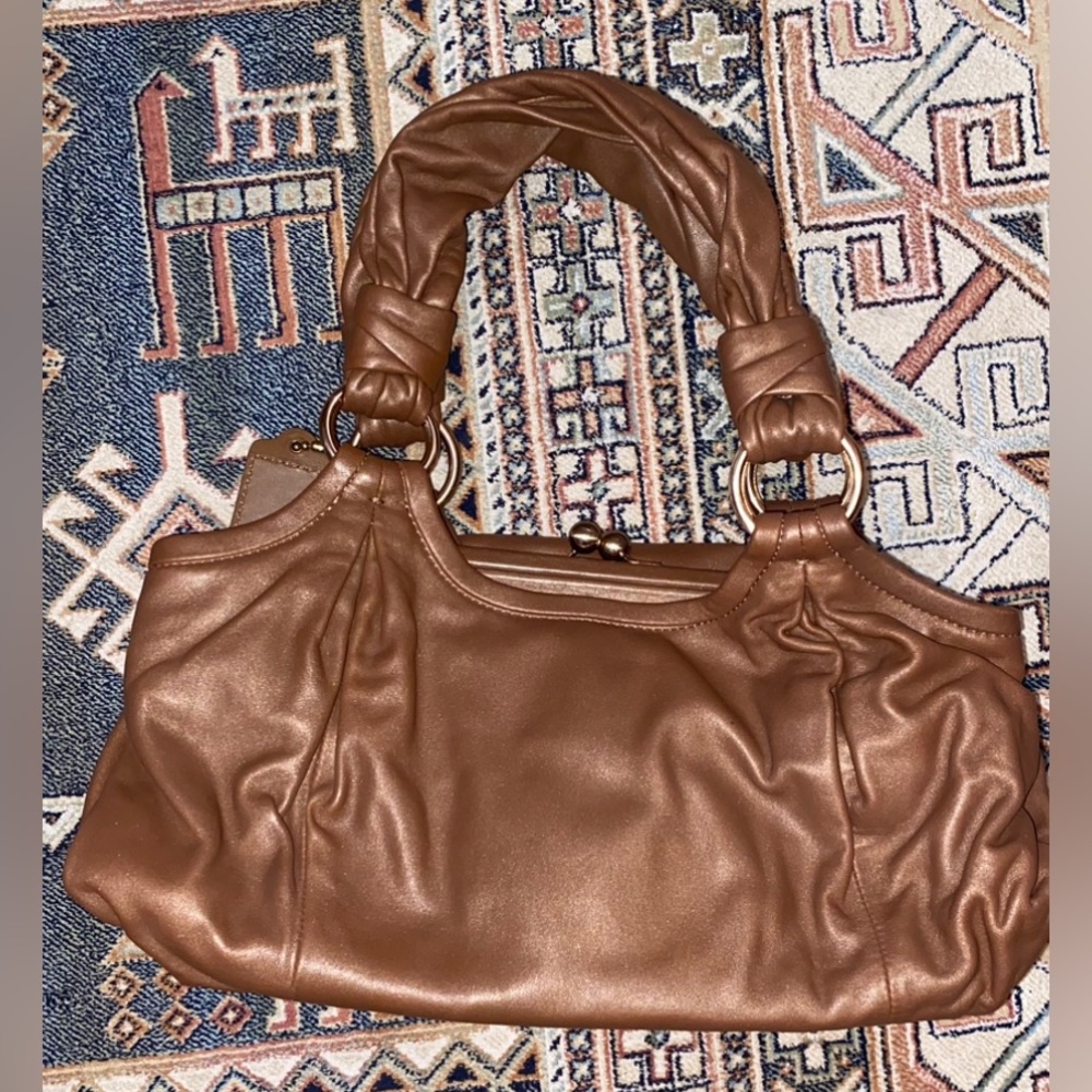 Vintage Coach bag with unique rose gold as clasp. light weight & smooth leather